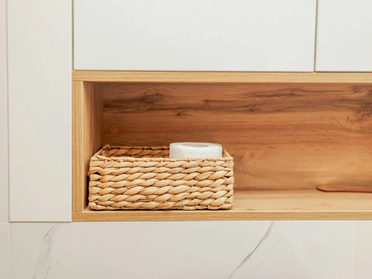 Wicker storage basket in a wooden wall niche
